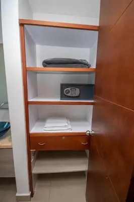 a closet with an open door with a towel and a clock at Excelente Apartamento Palmetto con vista al mar in Cartagena de Indias