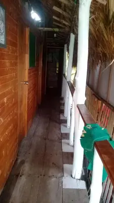 a hallway with benches and trees in a building at Cabaña Luna Azul in Playa Blanca
