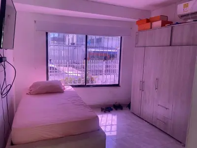 a small bedroom with a bed and a window at Alojamiento Arte y Salud in Cartagena de Indias