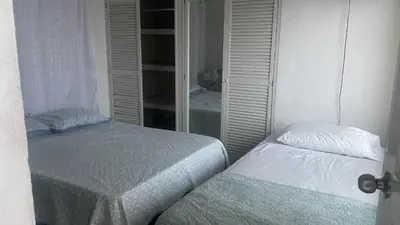 a bedroom with two beds and a mirror at Alojamiento Arte y Salud in Cartagena de Indias