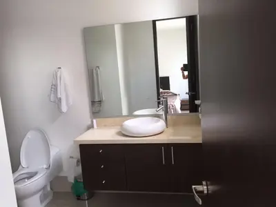 a bathroom with a sink and a toilet and a mirror at Pretty Apartment in Cartagena de Indias