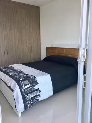 a bedroom with a bed with a black and white blanket at Pretty Apartment in Cartagena de Indias