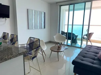a living room with a couch and chairs at Apartamento Frenta a la Playa in Cartagena de Indias