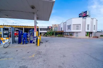 an empty gas station next to a gas pump at Hotel Baly Express in Malambo