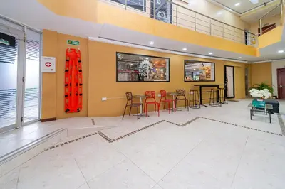 a large room with a table and chairs in it at Hotel Baly Express in Malambo