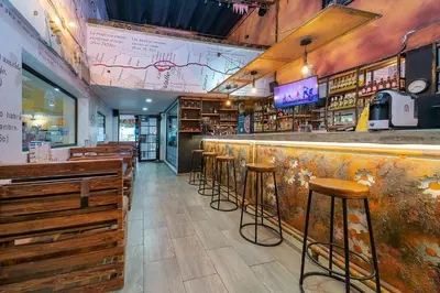 a bar with wooden stools in a restaurant at Hotel Baly Express in Malambo
