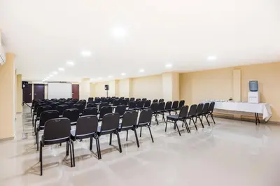 a large room with a bunch of chairs and a table at Ribai Hotels - Barranquilla in Barranquilla