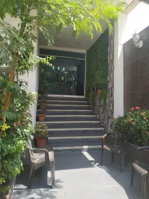 a hallway with stairs and chairs and potted plants at Hotel La Mar Cartagena in Cartagena de Indias