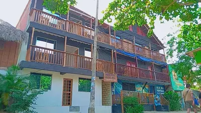a man standing in front of a building at Hostel Blue Sea Rincon del Mar in Rincón