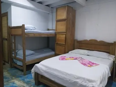 a bedroom with two bunk beds and a closet at Hostel Blue Sea Rincon del Mar in Rincón