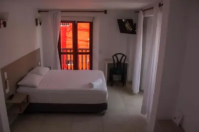 a bedroom with a bed and a window at Akel House Hotel in Cartagena de Indias