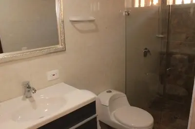 a bathroom with a toilet and a sink and a shower at Akel House Hotel in Cartagena de Indias