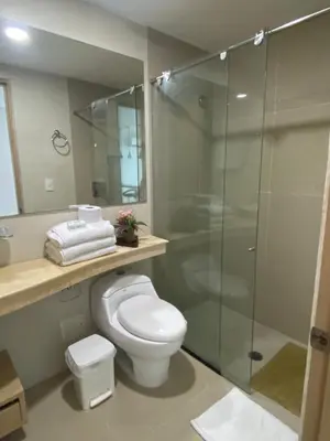 a bathroom with a toilet and a glass shower at Apartamentos en Morros Cartagena in Cartagena de Indias