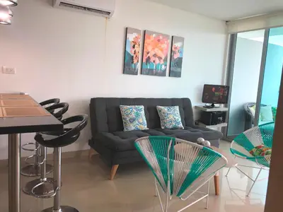 a living room with a couch and some chairs at Apartamentos en Morros Cartagena in Cartagena de Indias