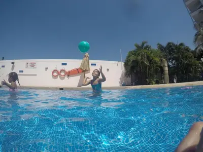 a woman playing with a ball in a swimming pool at Apartamentos en Morros Cartagena in Cartagena de Indias