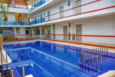 a large swimming pool in a large building at Awa De Mar Hotel Tolu in Tolú