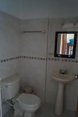 a bathroom with a toilet and a sink at Condominio Punta Bolivar in San Antero