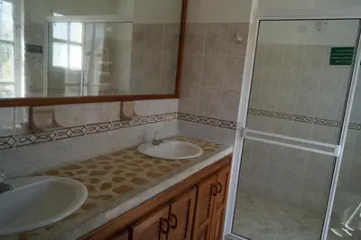 a bathroom with two sinks and a shower at Condominio Punta Bolivar in San Antero