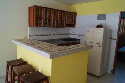 a kitchen with a stove and a refrigerator at Condominio Punta Bolivar in San Antero