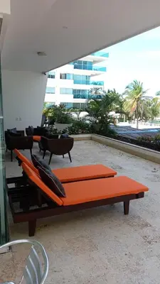 an orange bench sitting outside of a building at Apartamento Frente a la Playa Morros 922 in Cartagena de Indias