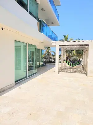 a large white building with a gate in front of it at Apartamento Frente a la Playa Morros 922 in Cartagena de Indias