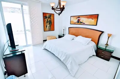 a bedroom with a bed and a flat screen tv at Apartamento Frente a la Playa Morros 922 in Cartagena de Indias