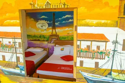 a bedroom with two beds and a painting of the eiffel tower at Nuestros Tres Tesoros II in Playa Blanca