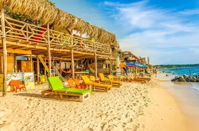 a group of chairs and umbrellas on a beach at Nuestros Tres Tesoros II in Playa Blanca