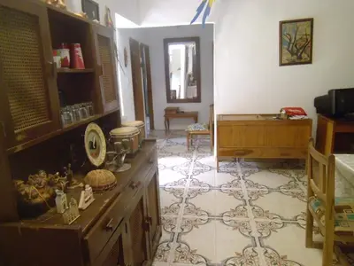 a living room with a table and a floor at Hostal Santa Clara in San Antero