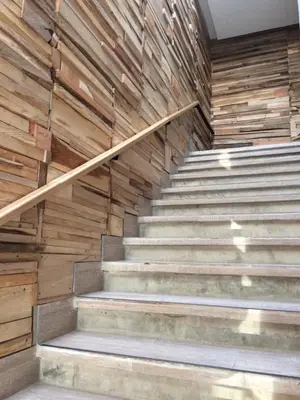 a set of stairs in a building with wooden walls at Hotel Hausen in Lorica