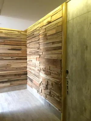 a room with a wall made of wood at Hotel Hausen in Lorica