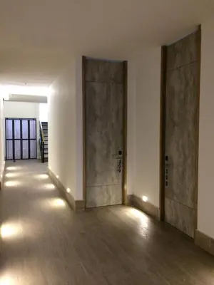 an empty room with two doors and wooden floors at Hotel Hausen in Lorica
