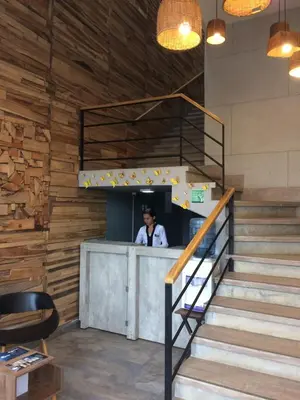a man standing at the counter of a restaurant at Hotel Hausen in Lorica