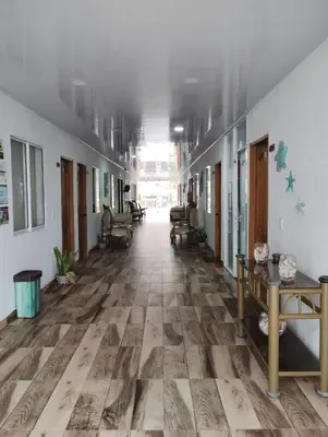 an empty hallway of a hospital with wooden floors at Hotel Sunset Beach in Cartagena de Indias
