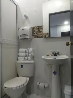 a bathroom with a toilet and a sink at Hotel Sunset Beach in Cartagena de Indias