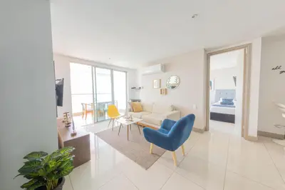 a living room with a couch and a table and chairs at Edificio Palmetto Beach Apto 1702 in Cartagena de Indias
