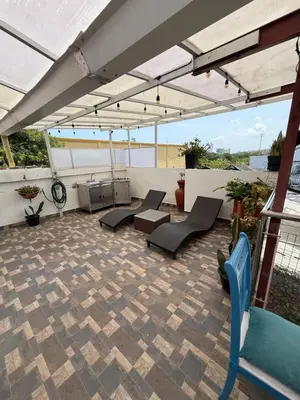 a patio with chairs and tables on a roof at Casa Colonial Serrezuela in Cartagena de Indias