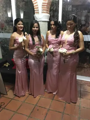 a group of women in pink dresses posing for a picture at Casa Colonial Serrezuela in Cartagena de Indias