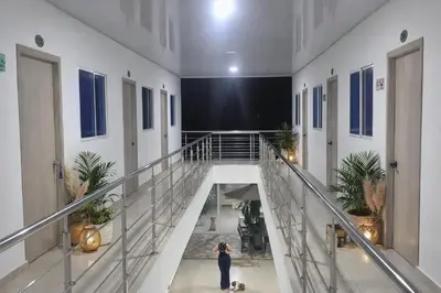 a woman taking a picture of a hallway in a building at Hotel Don Toño Tolú in Tolú