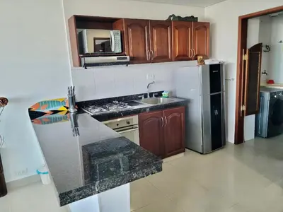 a kitchen with a counter top and a refrigerator at Torres del Lago Apartamentos in Cartagena de Indias