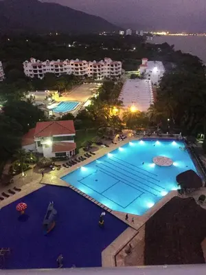 an overhead view of a large swimming pool at night at Costa Azul Suites 401 in Santa Marta