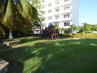 a playground in a park in front of a building at Costa Azul Suites 401 in Santa Marta