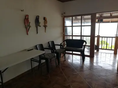 a room with chairs and a table and windows at Casa Madrigueña in Rincón