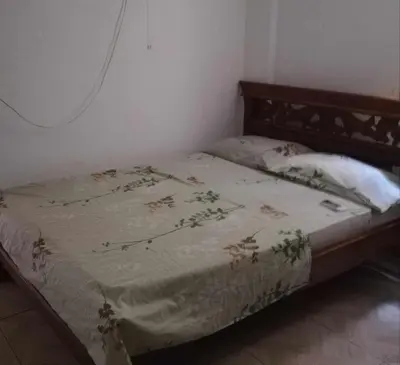 a bed in a bedroom with a blanket on it at Casa Madrigueña in Rincón