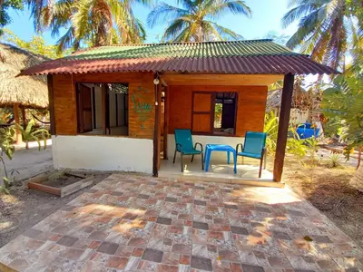 a small house with two chairs and a table at Eco Hotel Campo Verde in Isla Grande
