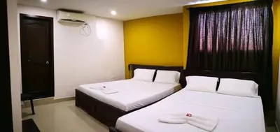 a bedroom with two beds and a television in it at Hotel Diamante Real Cienaga in Ciénaga