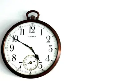 a clock hanging on a wall at Hotel Diamante Real Cienaga in Ciénaga