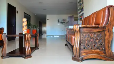 a room with two wooden chairs and a table at Hotel Diamante Real Cienaga in Ciénaga