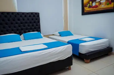 two beds sitting next to each other in a room at Cabanas Villa Antonella Covenas in Coveñas