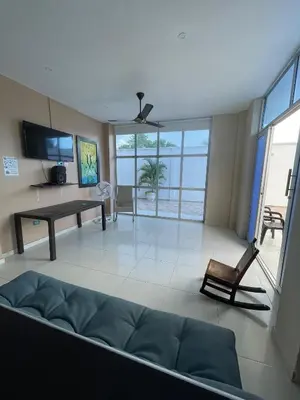 a living room with a couch and a table at Cabanas Villa Antonella Covenas in Coveñas